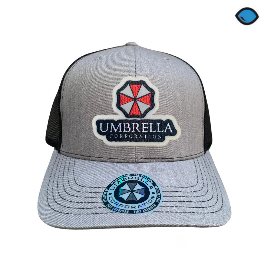 Gorra Resident Evil “Umbrella Corporation” Gris-Negra Premium Trucker